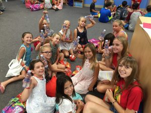 Children smiling and holding YLWD Water Bottles