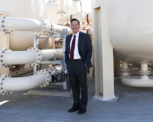 Mark Toy standing in front of 22 ft tall ion exchange vessels