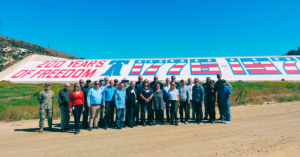 Tour participants standing in front of Prado Dam Mural