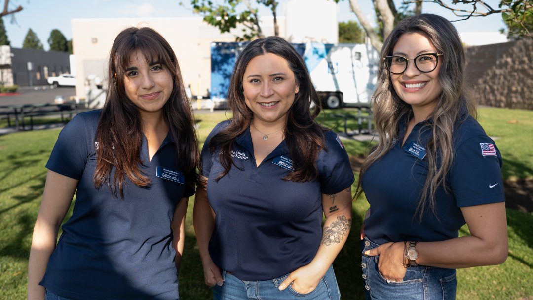 The YLWD Public Affairs Team poses together outdoors, smiling in a group photo.