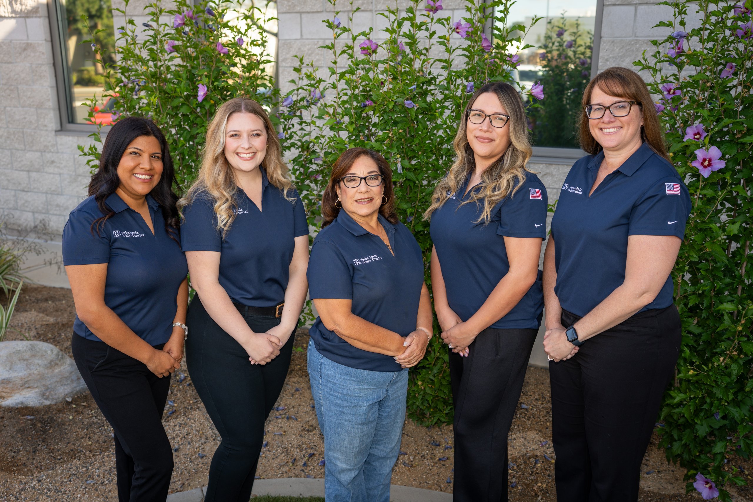 Customer Service staff members posed in front of district headquarters