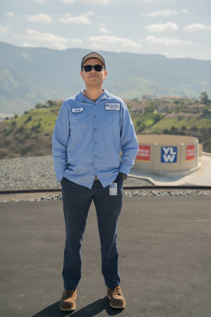 District staff member posed in front of water infrastructure